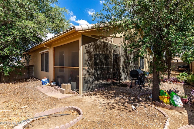 7157 W Odyssey Way, Tucson, AZ 85743 - view of side of home featuring a tile roof, a fenced backyard, and stucco siding