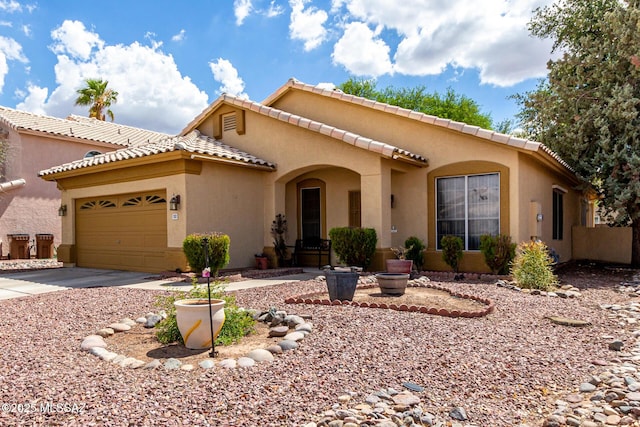 7157 W Odyssey Way, Tucson, AZ 85743 - mediterranean / spanish-style house featuring an attached garage, stucco siding, concrete driveway, and a tiled roof