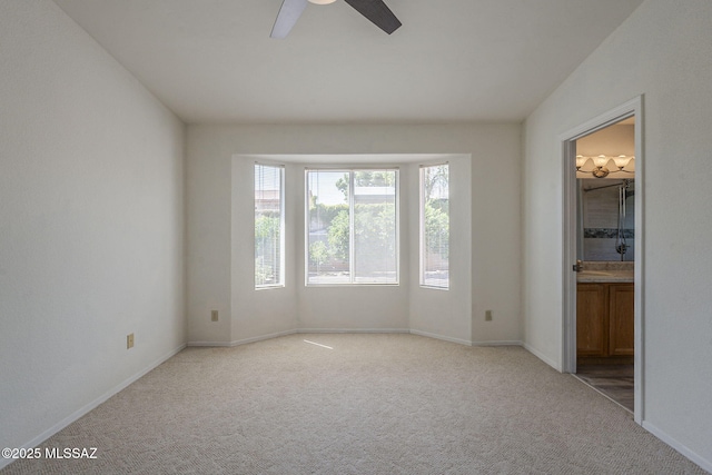 8954 E Pomegranate St, Tucson, AZ 85730 - unfurnished bedroom featuring light colored carpet, ensuite bath, and a ceiling fan