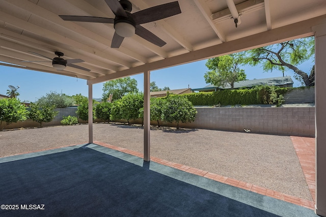 8954 E Pomegranate St, Tucson, AZ 85730 - fenced backyard with a ceiling fan and a patio area