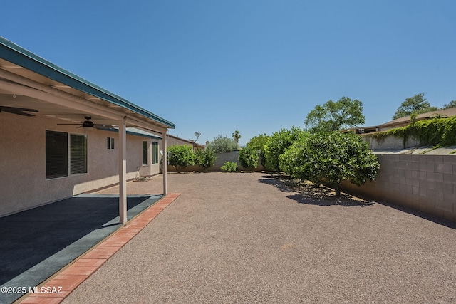 8954 E Pomegranate St, Tucson, AZ 85730 - fenced backyard featuring a ceiling fan and a patio