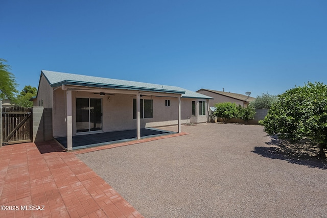 8954 E Pomegranate St, Tucson, AZ 85730 - rear view of house featuring ceiling fan, stucco siding, a patio area, a fenced backyard, and a gate