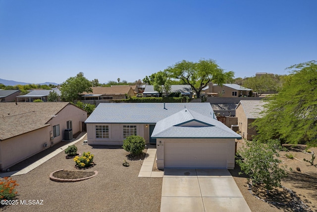 8954 E Pomegranate St, Tucson, AZ 85730 - ranch-style home with concrete driveway, a residential view, an attached garage, and a mountain view