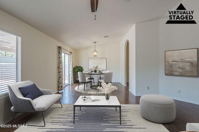 8954 E Pomegranate St, Tucson, AZ 85730 - living room with arched walkways, lofted ceiling, and wood finished floors
