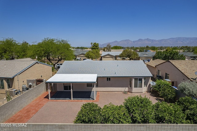 8954 E Pomegranate St, Tucson, AZ 85730 - back of house featuring a patio area, a residential view, a mountain view, a fenced backyard, and stucco siding
