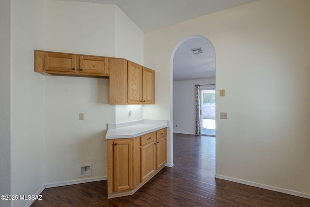 8954 E Pomegranate St, Tucson, AZ 85730 - kitchen with arched walkways, dark wood-type flooring, and light countertops