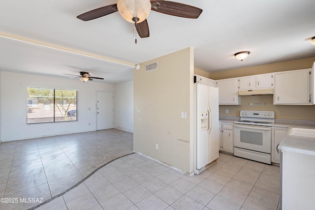 2340 S Window Rock Pl, Tucson, AZ 85710 - kitchen with white appliances, under cabinet range hood, ceiling fan, and light countertops