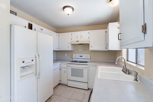 2340 S Window Rock Pl, Tucson, AZ 85710 - kitchen with white appliances, under cabinet range hood, a sink, light countertops, and light tile patterned flooring