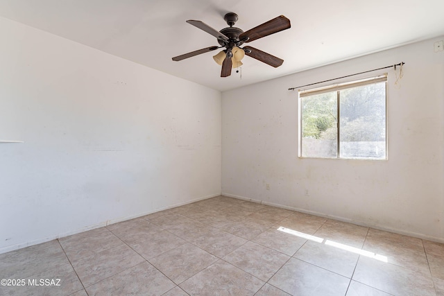 2340 S Window Rock Pl, Tucson, AZ 85710 - empty room featuring a ceiling fan, light tile patterned flooring, and baseboards