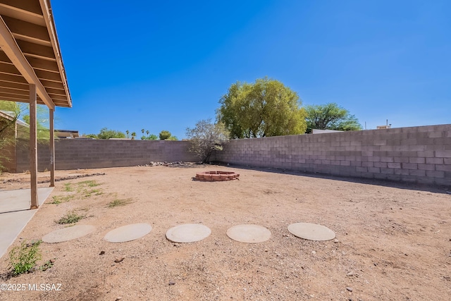 2340 S Window Rock Pl, Tucson, AZ 85710 - fenced backyard featuring a fire pit