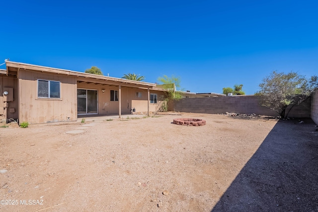 2340 S Window Rock Pl, Tucson, AZ 85710 - rear view of house with an outdoor fire pit and a fenced backyard