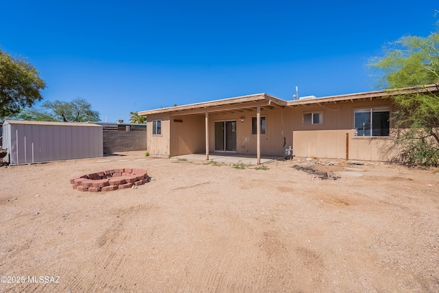 2340 S Window Rock Pl, Tucson, AZ 85710 - rear view of property featuring a fire pit and a patio