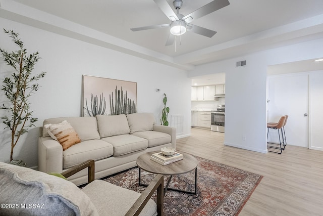 4203 N River Grove Cir Unit 103, Tucson, AZ 85719 - living area with light wood-style flooring, ceiling fan, and baseboards