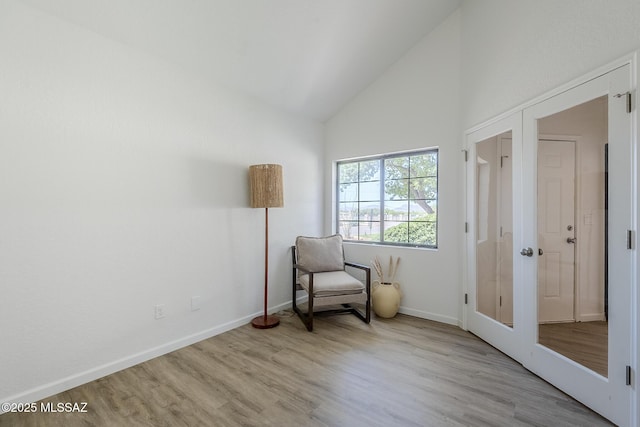 4203 N River Grove Cir Unit 103, Tucson, AZ 85719 - living area featuring wood finished floors, baseboards, and high vaulted ceiling