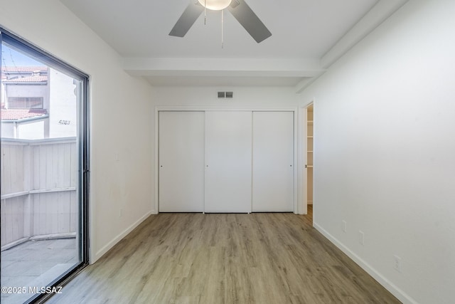 4203 N River Grove Cir Unit 103, Tucson, AZ 85719 - unfurnished bedroom with wood finished floors, a closet, baseboards, and a ceiling fan