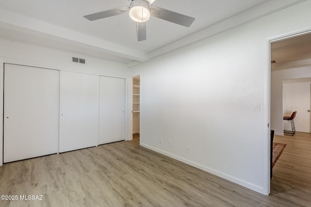 4203 N River Grove Cir Unit 103, Tucson, AZ 85719 - unfurnished bedroom featuring wood finished floors, a closet, baseboards, and ceiling fan