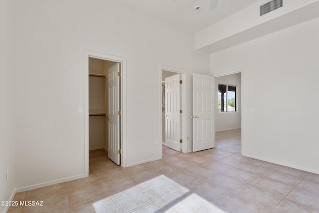 14243 E Whisper Trl, Vail, AZ 85641 - unfurnished bedroom featuring a spacious closet, a closet, and light tile patterned floors
