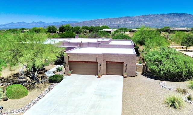 14243 E Whisper Trl, Vail, AZ 85641 - view of front of home featuring an attached garage, a mountain view, stucco siding, driveway, and a chimney