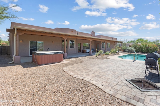 14243 E Whisper Trl, Vail, AZ 85641 - back of house featuring a hot tub, a patio area, and stucco siding