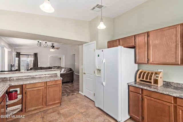 8172 N Streamside Ave, Tucson, AZ 85741 - kitchen featuring white refrigerator with ice dispenser, open floor plan, decorative light fixtures, and brown cabinetry
