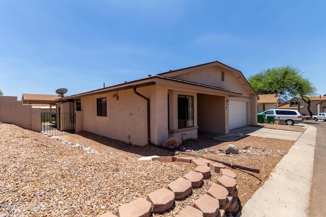 8172 N Streamside Ave, Tucson, AZ 85741 - view of property exterior featuring stucco siding, driveway, and an attached garage