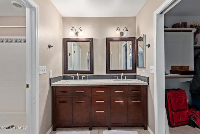8172 N Streamside Ave, Tucson, AZ 85741 - bathroom with double vanity and a textured wall