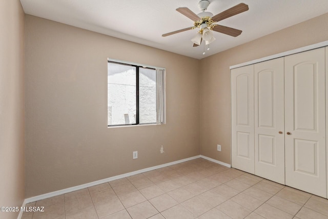 8172 N Streamside Ave, Tucson, AZ 85741 - unfurnished bedroom featuring a closet, baseboards, light tile patterned flooring, and a ceiling fan