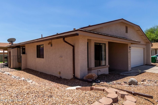 8172 N Streamside Ave, Tucson, AZ 85741 - view of home's exterior featuring stucco siding, driveway, and a garage