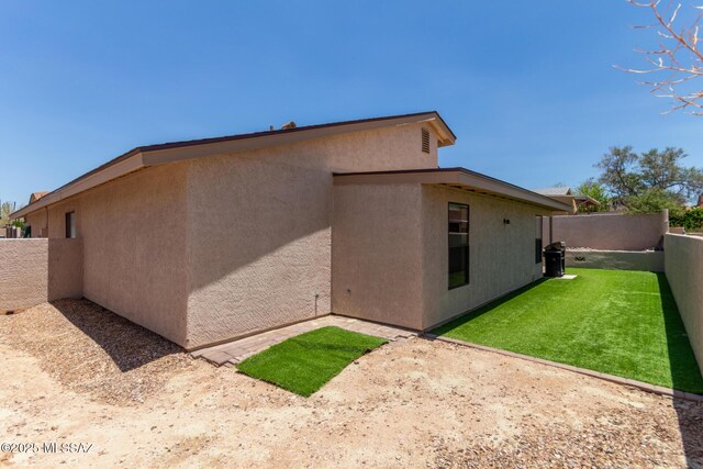 8172 N Streamside Ave, Tucson, AZ 85741 - view of home's exterior with stucco siding and a patio area