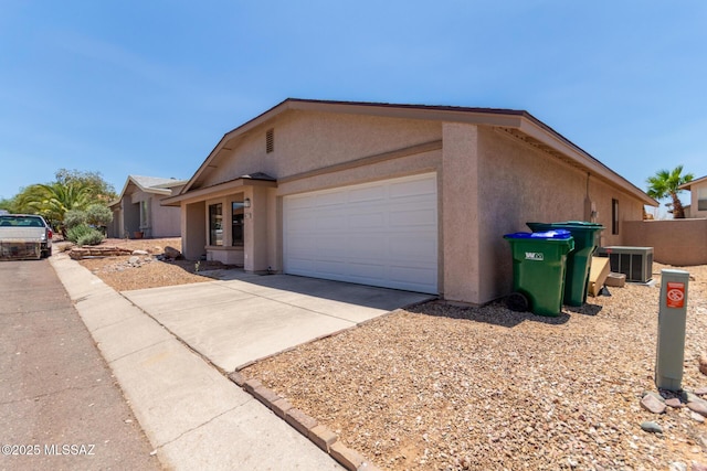 8172 N Streamside Ave, Tucson, AZ 85741 - view of front of home with stucco siding, a garage, and driveway