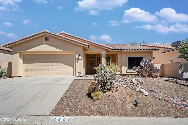 9860 N Western Sky Pl, Tucson, AZ 85742 - view of front of property with an attached garage, a tile roof, concrete driveway, and stucco siding