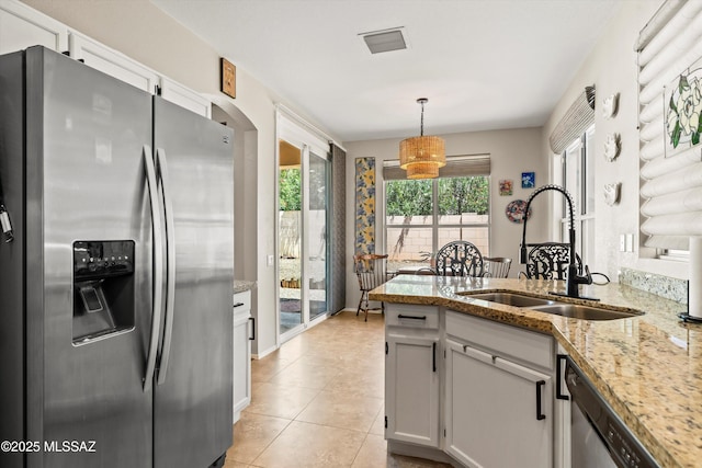 9860 N Western Sky Pl, Tucson, AZ 85742 - kitchen with stainless steel appliances, a sink, light stone countertops, a peninsula, and white cabinets