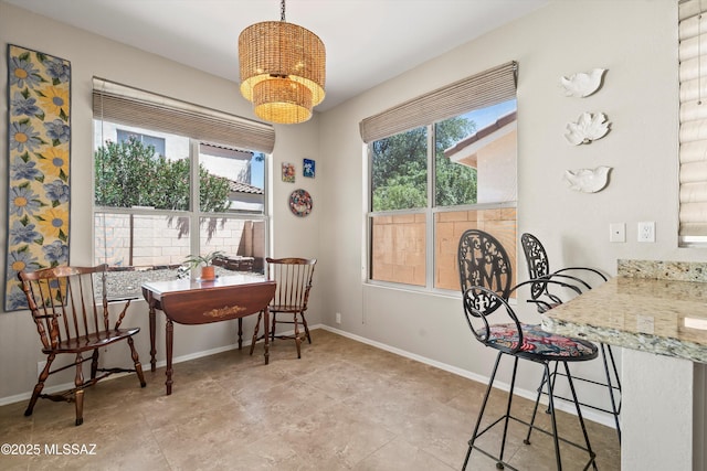 9860 N Western Sky Pl, Tucson, AZ 85742 - dining space with a chandelier, plenty of natural light, and baseboards