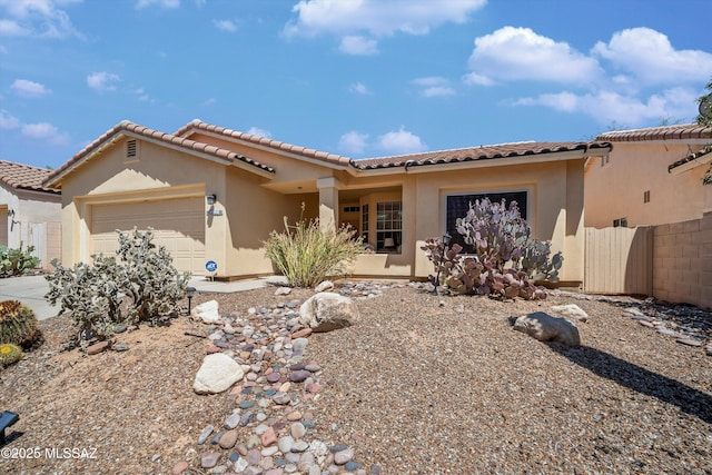 9860 N Western Sky Pl, Tucson, AZ 85742 - view of front of property featuring an attached garage, stucco siding, and a tile roof