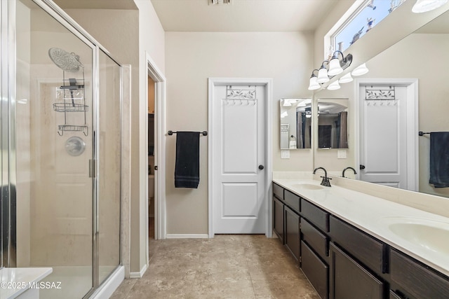 9860 N Western Sky Pl, Tucson, AZ 85742 - bathroom featuring double vanity, a shower stall, and baseboards