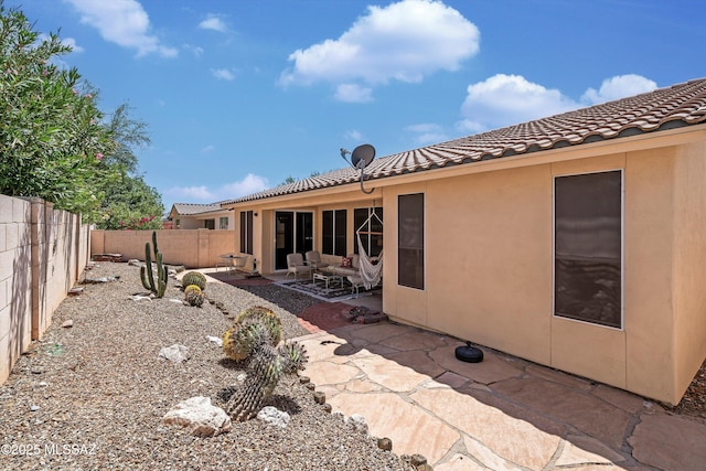 9860 N Western Sky Pl, Tucson, AZ 85742 - rear view of house featuring a tiled roof, stucco siding, a fenced backyard, and a patio area