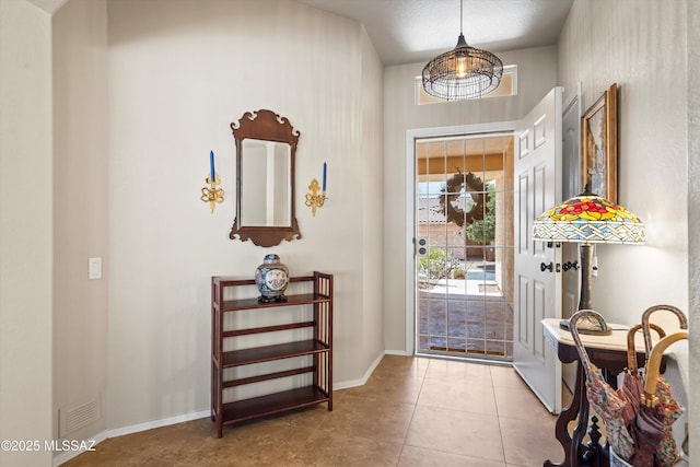 9860 N Western Sky Pl, Tucson, AZ 85742 - entryway featuring tile patterned flooring and baseboards