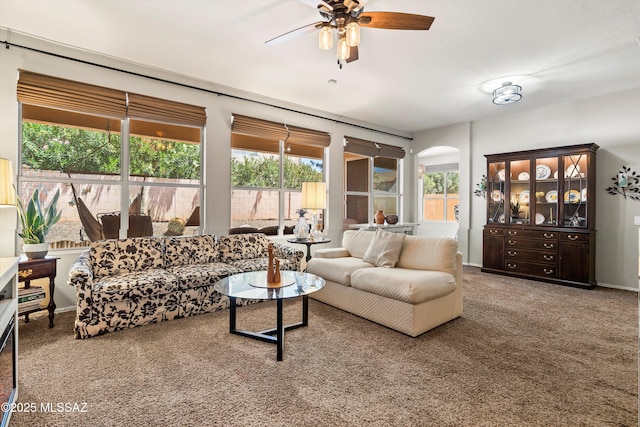 9860 N Western Sky Pl, Tucson, AZ 85742 - living room featuring a ceiling fan, arched walkways, and carpet floors