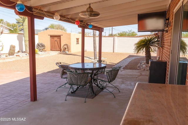 1117 S Carnegie Dr, Tucson, AZ 85710 - fenced backyard with outdoor dining space and a patio