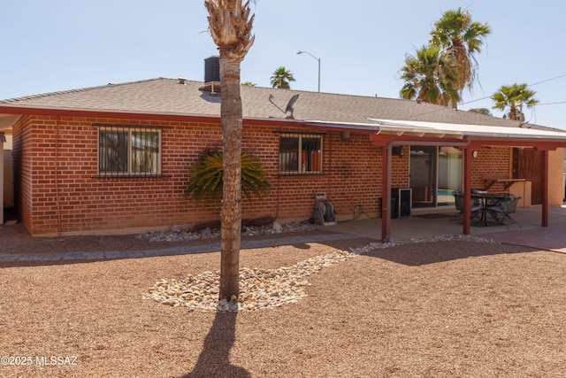 1117 S Carnegie Dr, Tucson, AZ 85710 - back of house with brick siding, a patio, and a shingled roof
