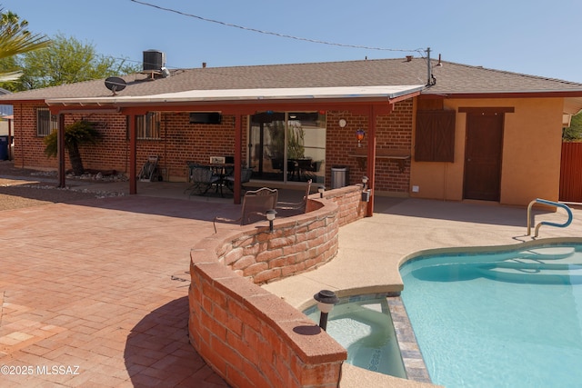 1117 S Carnegie Dr, Tucson, AZ 85710 - rear view of property featuring a patio area, brick siding, roof with shingles, and a pool with connected hot tub