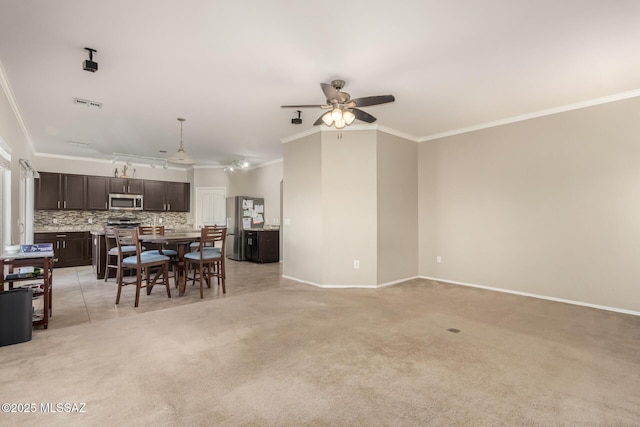 6733 S Stone Fly Dr, Tucson, AZ 85757 - dining space featuring crown molding, ceiling fan, light colored carpet, and baseboards