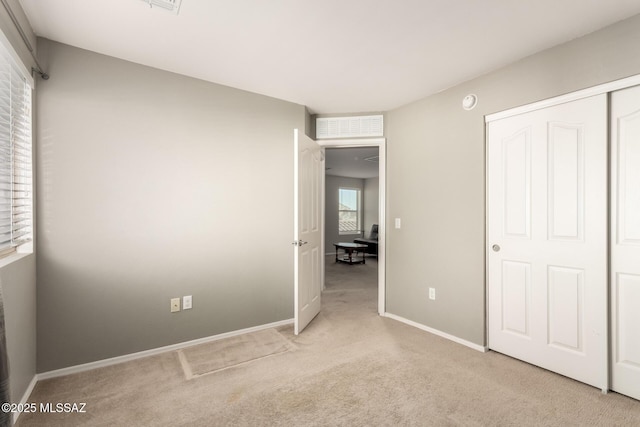 6733 S Stone Fly Dr, Tucson, AZ 85757 - unfurnished bedroom with light carpet, baseboards, and a closet