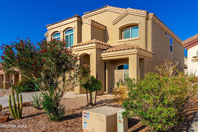 6733 S Stone Fly Dr, Tucson, AZ 85757 - mediterranean / spanish house featuring a tiled roof and stucco siding