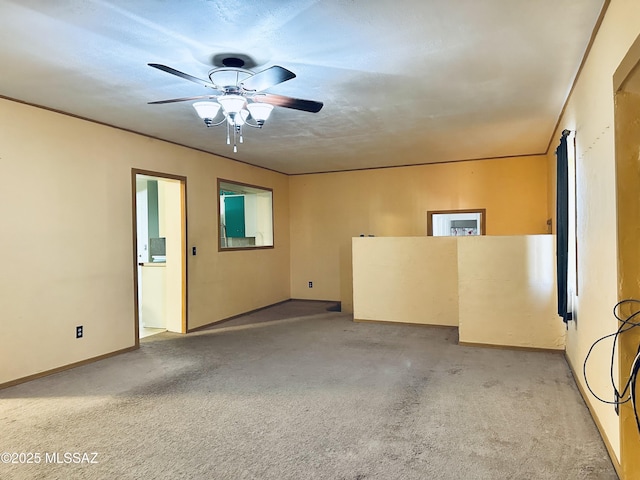 41 S Main St, Pima, AZ 85543 - empty room with light colored carpet, ceiling fan, and baseboards