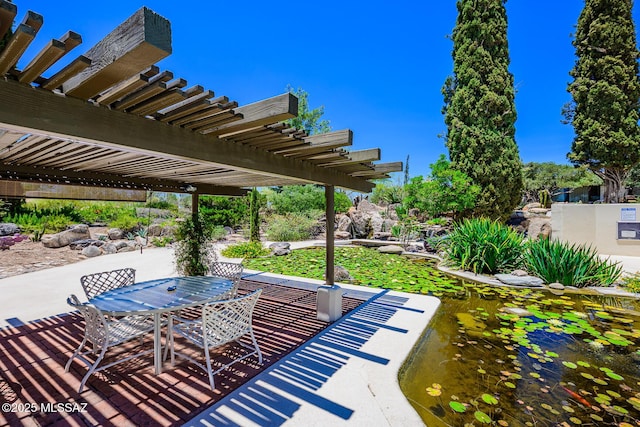 2600 E Skyline Dr Unit 21, Tucson, AZ 85718 - view of patio / terrace with a pergola, a garden pond, and outdoor dining space