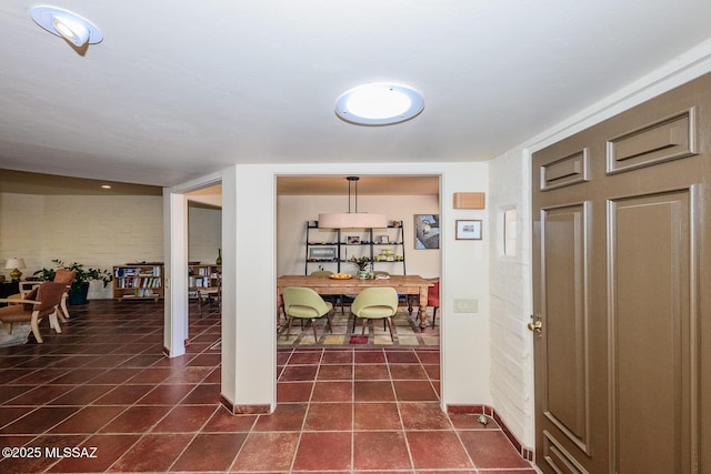 2600 E Skyline Dr Unit 21, Tucson, AZ 85718 - entrance foyer with dark tile patterned flooring and baseboards