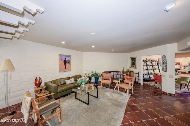 2600 E Skyline Dr Unit 21, Tucson, AZ 85718 - living room with brick wall, recessed lighting, and dark tile patterned floors