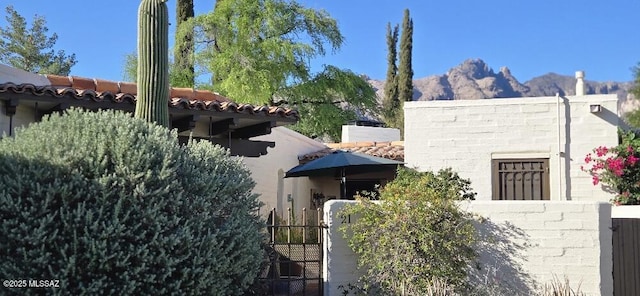 2600 E Skyline Dr Unit 21, Tucson, AZ 85718 - view of front of house featuring a mountain view, a tile roof, and a gate