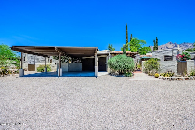 2600 E Skyline Dr Unit 21, Tucson, AZ 85718 - view of front of property with a mountain view, gravel driveway, and an attached carport